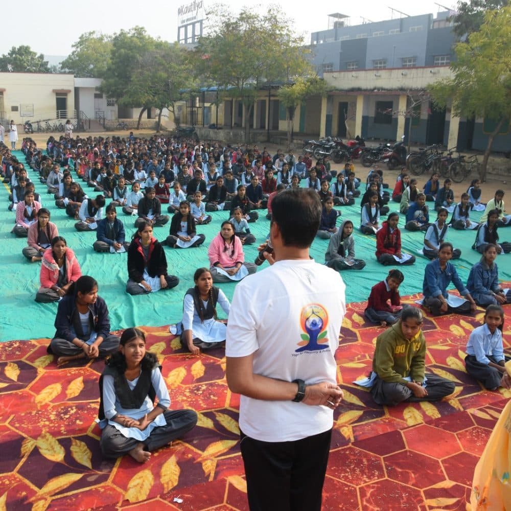 A large outdoor yoga session with school students
